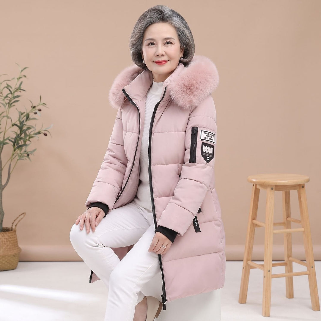 Thessaline hooded puffer jacket with pink faux fur collar, seated side view