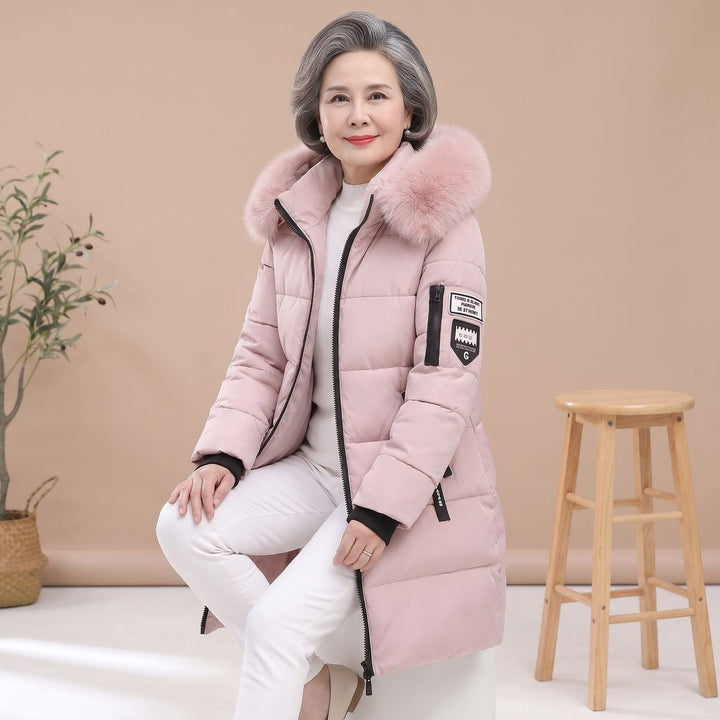 Thessaline hooded puffer jacket with pink faux fur collar, seated side view