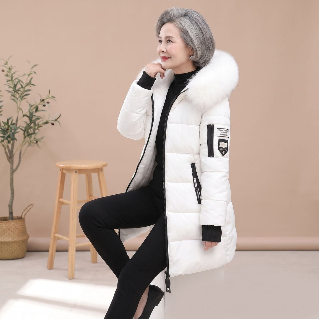 Thessaline hooded puffer jacket with pink faux fur collar, seated side view