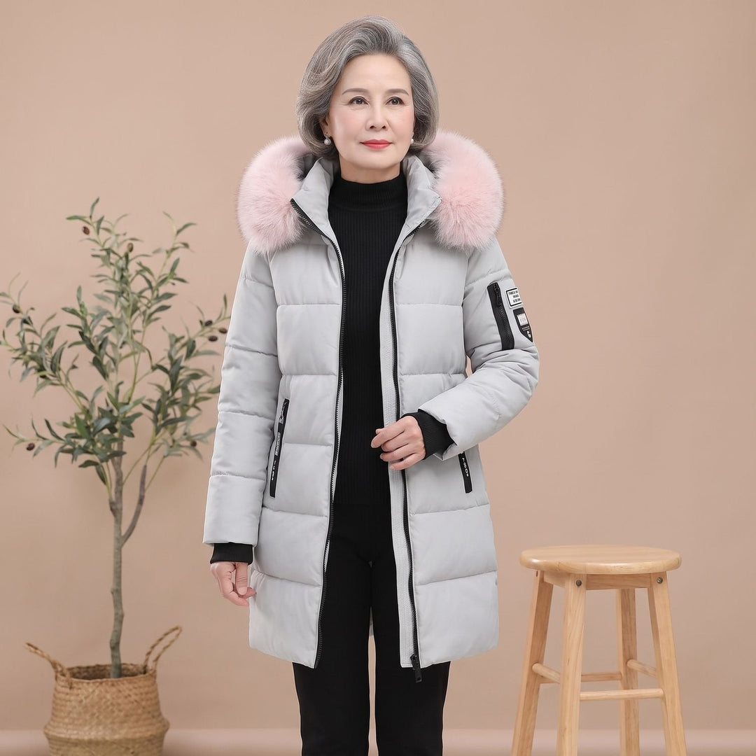 Thessaline hooded puffer jacket with pink faux fur collar, seated side view