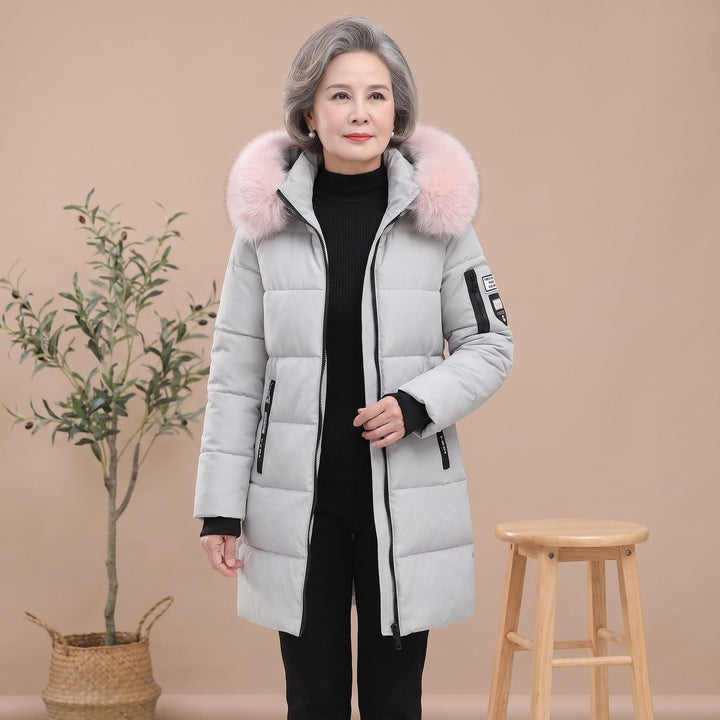 Thessaline hooded puffer jacket with pink faux fur collar, seated side view