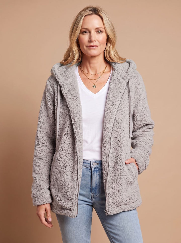 Faustina hooded teddy fleece jacket in beige, front view with hands in pockets
