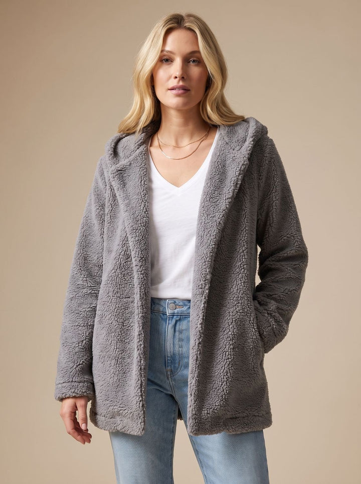 Faustina hooded teddy fleece jacket in beige, front view with hands in pockets