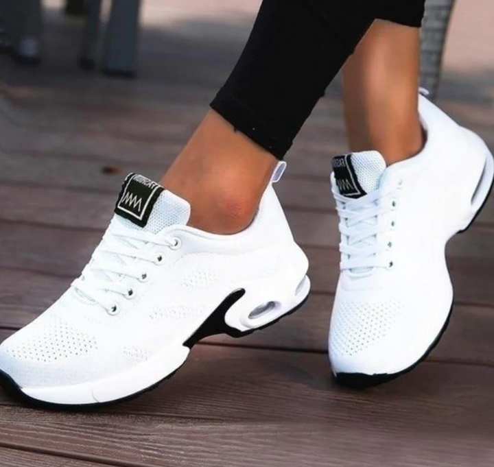 Felicity white lace-up cushioned sneakers, side view on feet