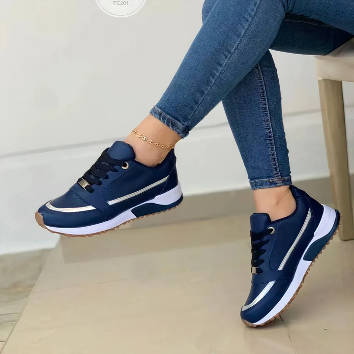 Annalise navy lace-up sneakers with metallic trim, side view on model