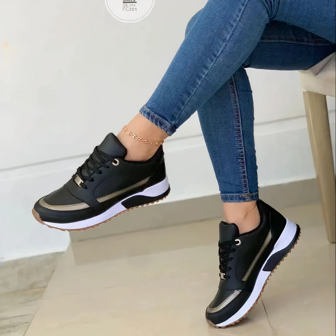 Annalise black lace-up sneakers with metallic trim, side view on model