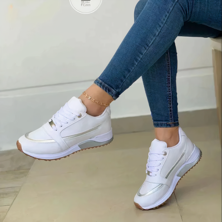 Annalise white lace-up sneakers with metallic trim, side view on model