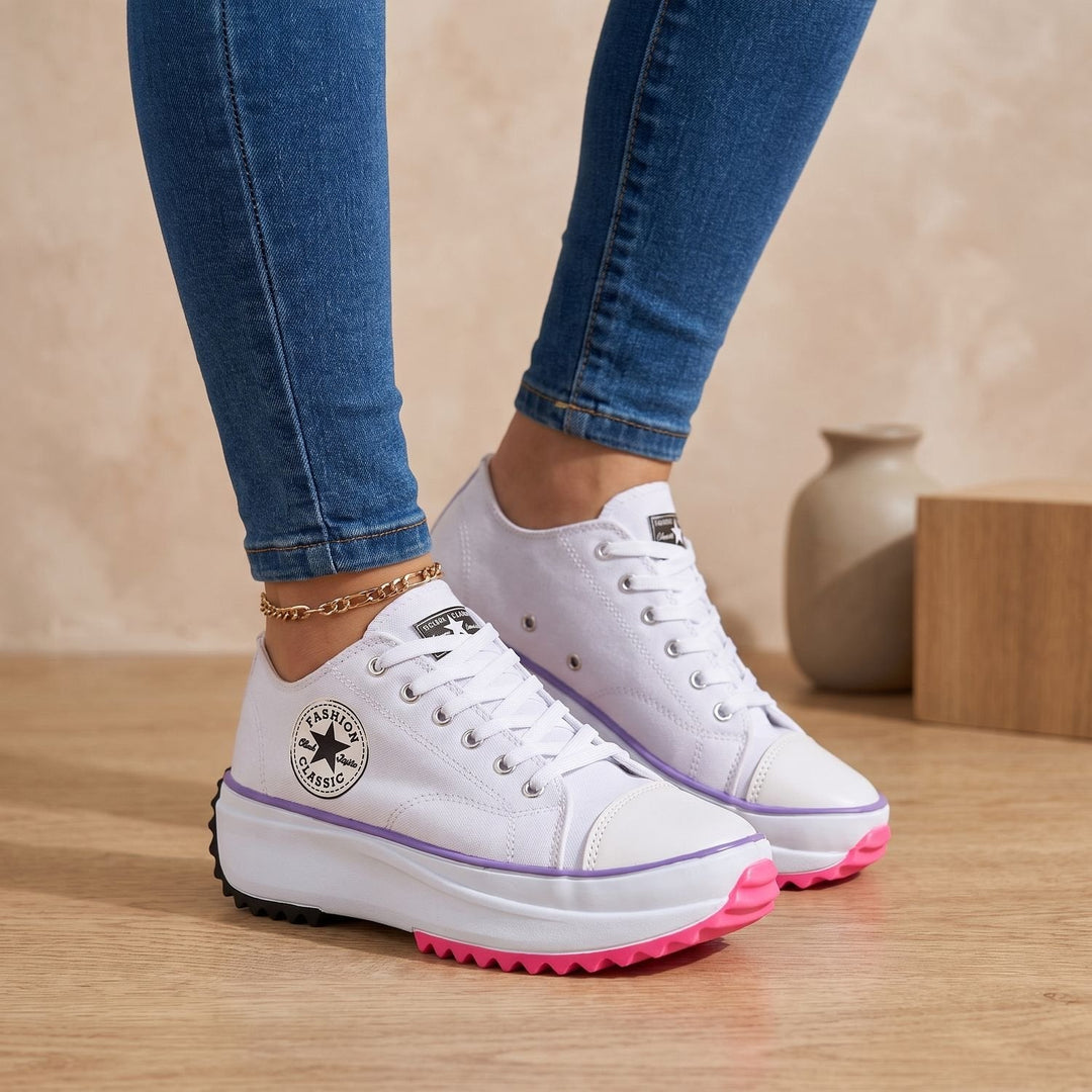White lace-up platform sneakers with purple and pink outsole, side view on model