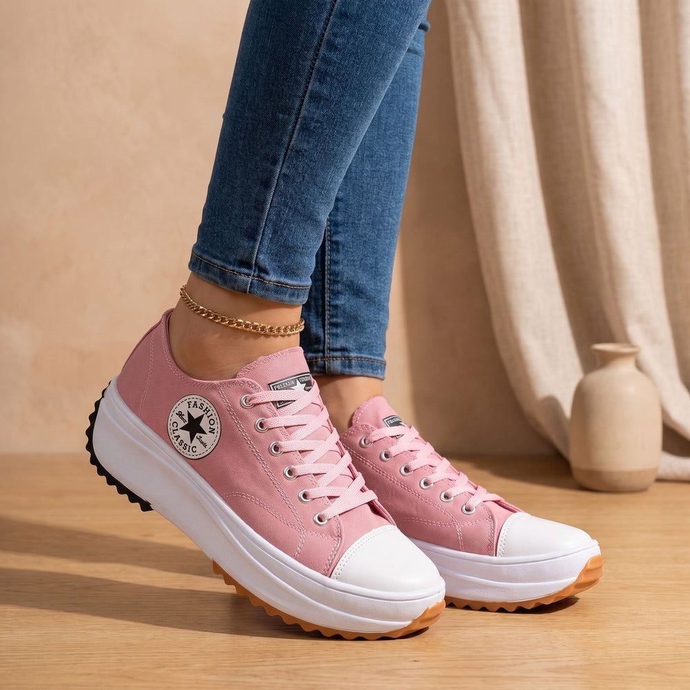 Pink lace-up platform sneakers with gum outsole, side view on model