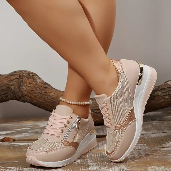 Faustine pink walking sneakers worn on feet, angled view
