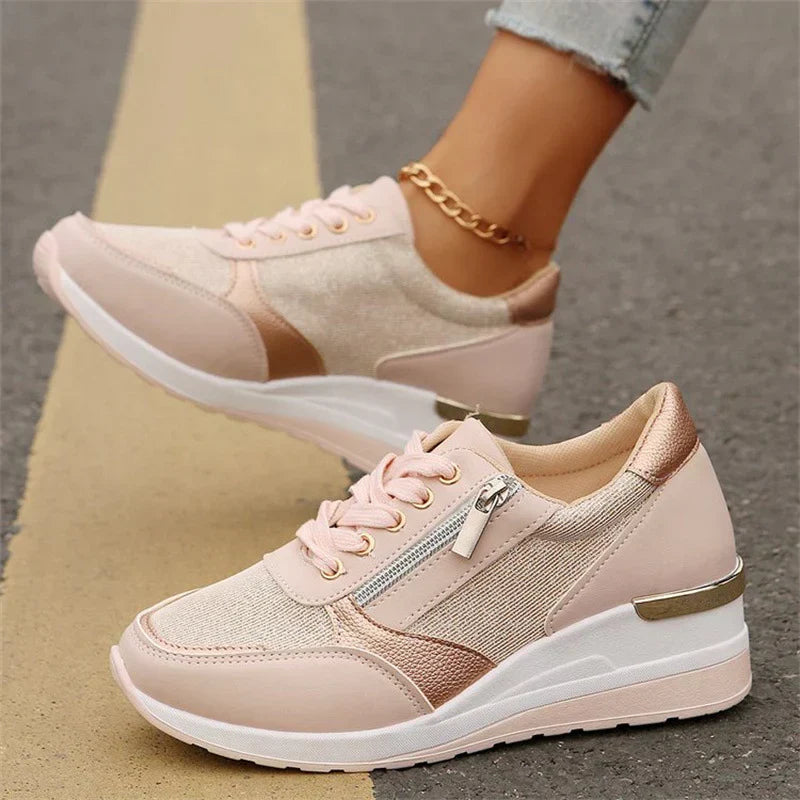 Faustine pink walking sneakers worn on feet, angled view