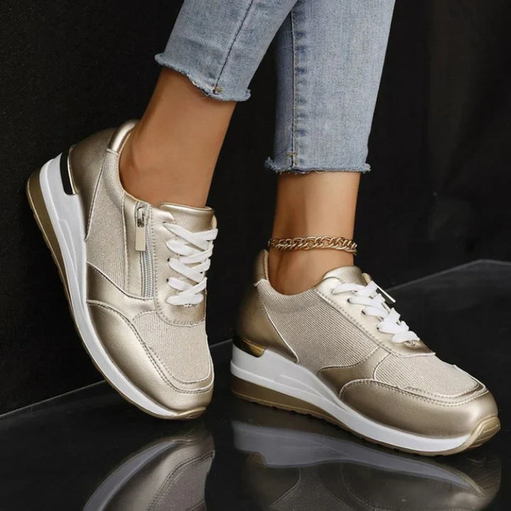Faustine pink walking sneakers worn on feet, angled view