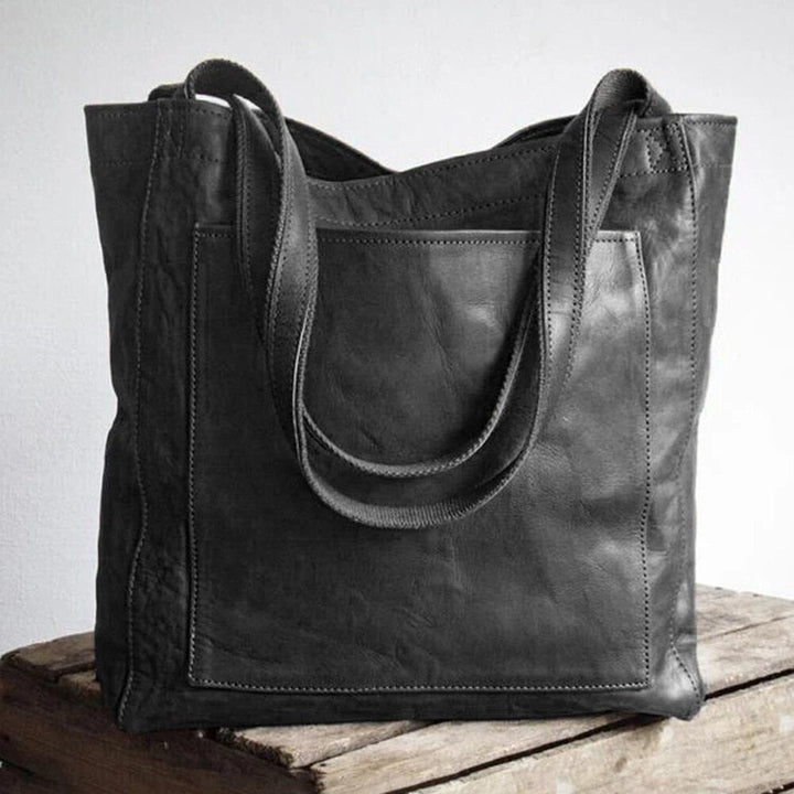Marisabel leather tote bag in dark shade, front pocket and straps detail