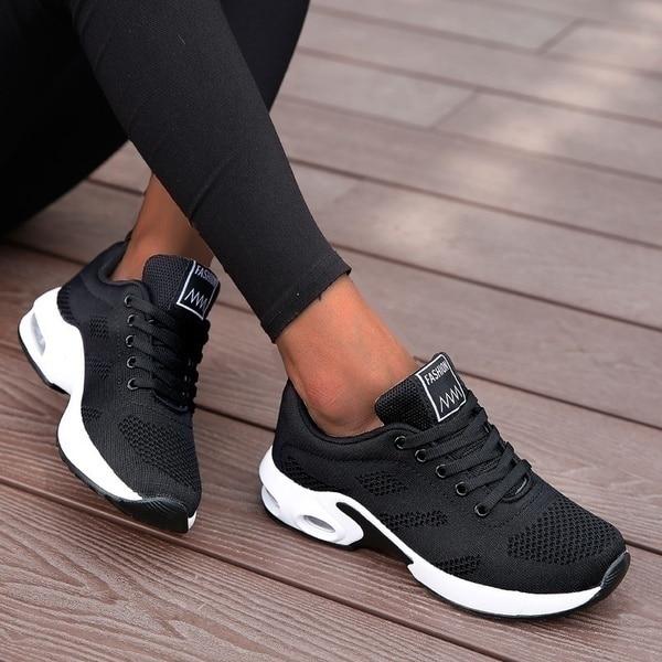 Marguerite black and white lace-up sneakers, side view on model