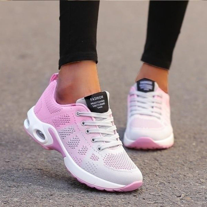 Marguerite pink and white lace-up sneakers, close-up on model