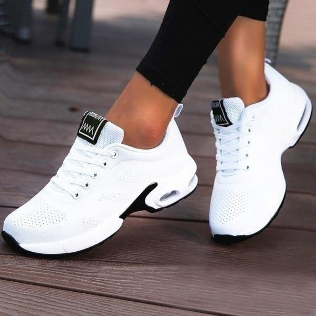 Marguerite pink and white lace-up sneakers, close-up on model