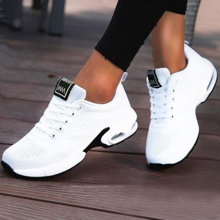 Marguerite pink and white lace-up sneakers, close-up on model