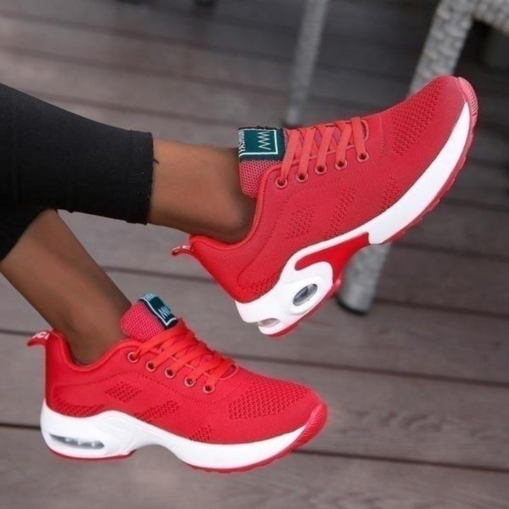 Marguerite pink and white lace-up sneakers, close-up on model