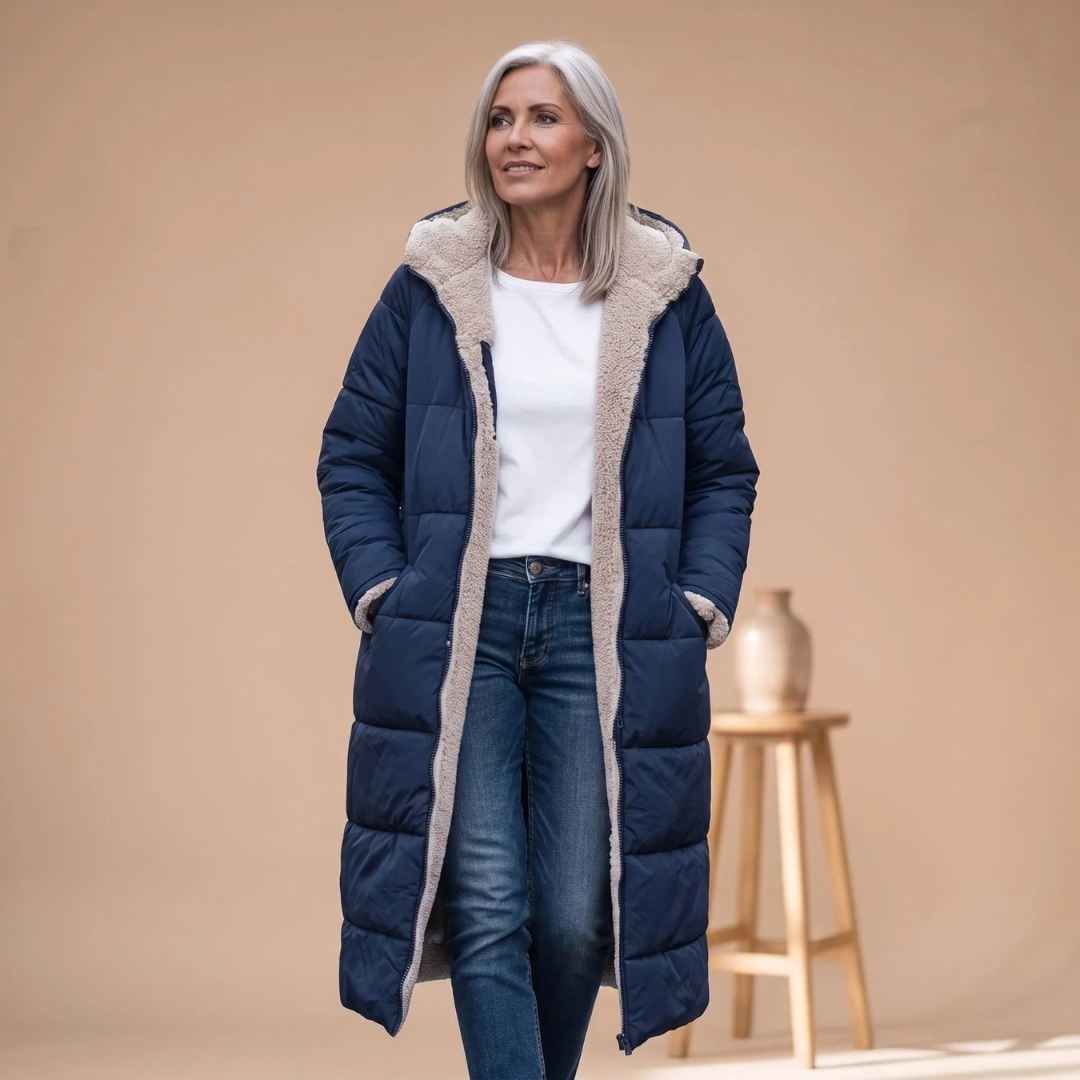 Rosalind long winter puffer jacket in navy, worn open over jeans