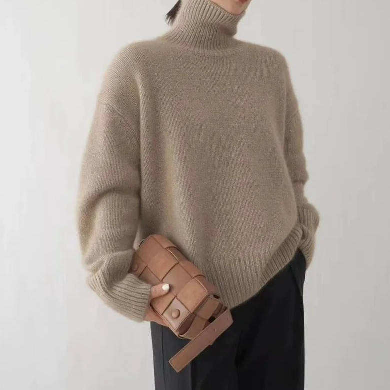 Thessaly turtleneck sweater detail, hand at collar