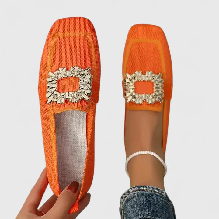 Odessa orange embellished buckle loafers, top and side view on model
