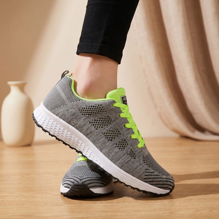 White lace-up mesh sneakers close-up showing cushioned sole and textured upper