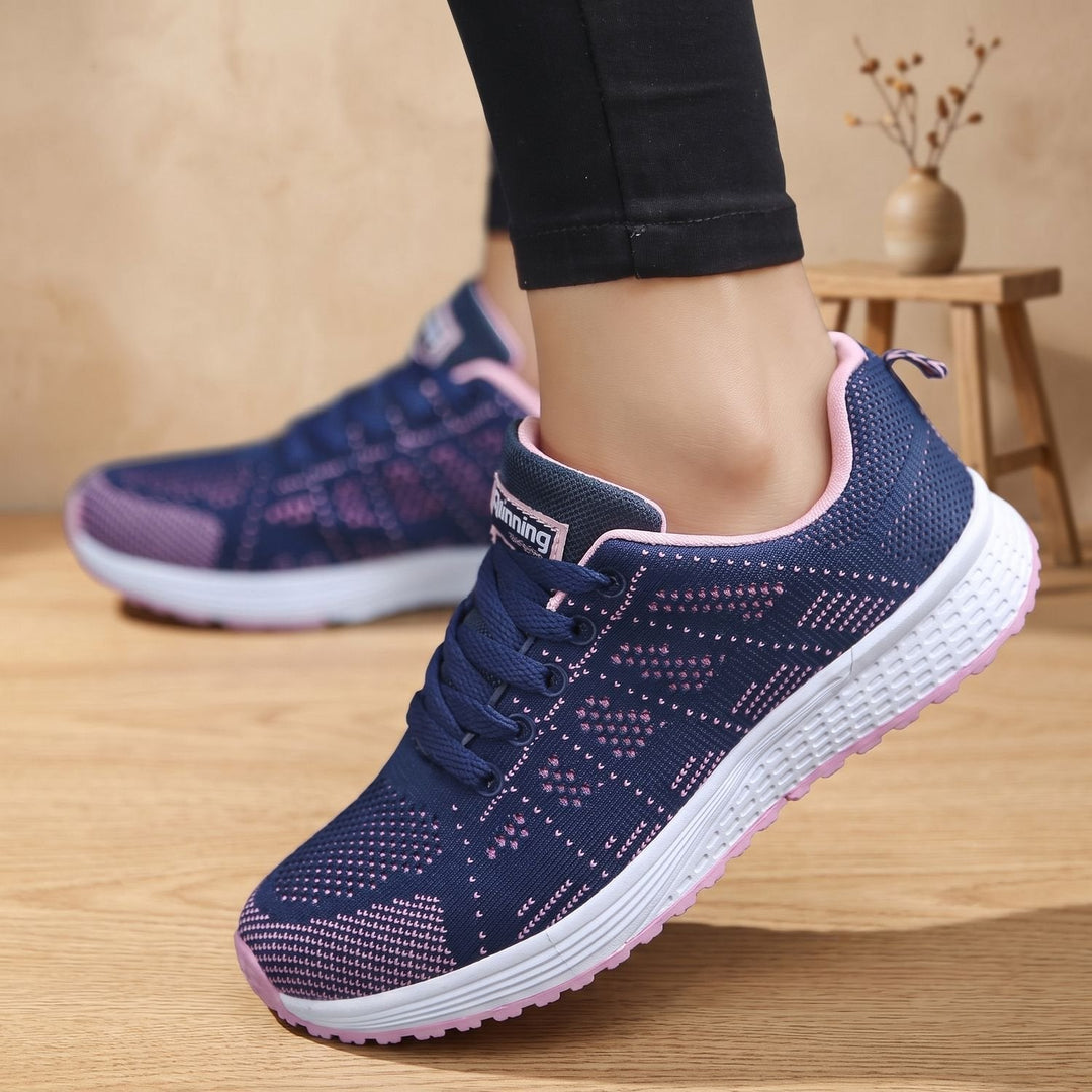 White lace-up mesh sneakers close-up showing cushioned sole and textured upper