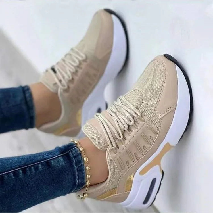 Lucinda beige and gold platform sneakers worn on feet, side view
