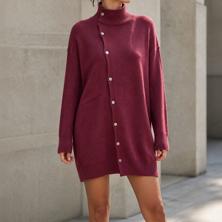 Guinevere oversized turtleneck sweater dress styled with ankle boots, seated side view