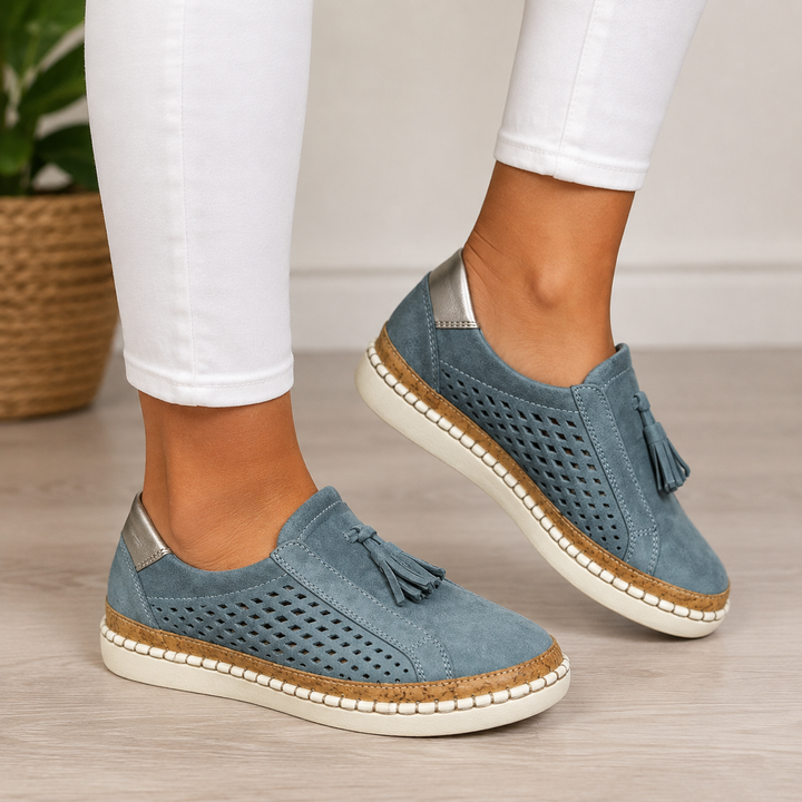 Marisette blue perforated loafers with metallic heel trim, close-up on feet