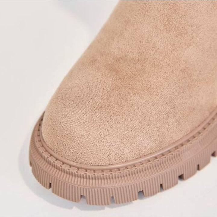 Wynne apricot winter boots, side profile held by hand