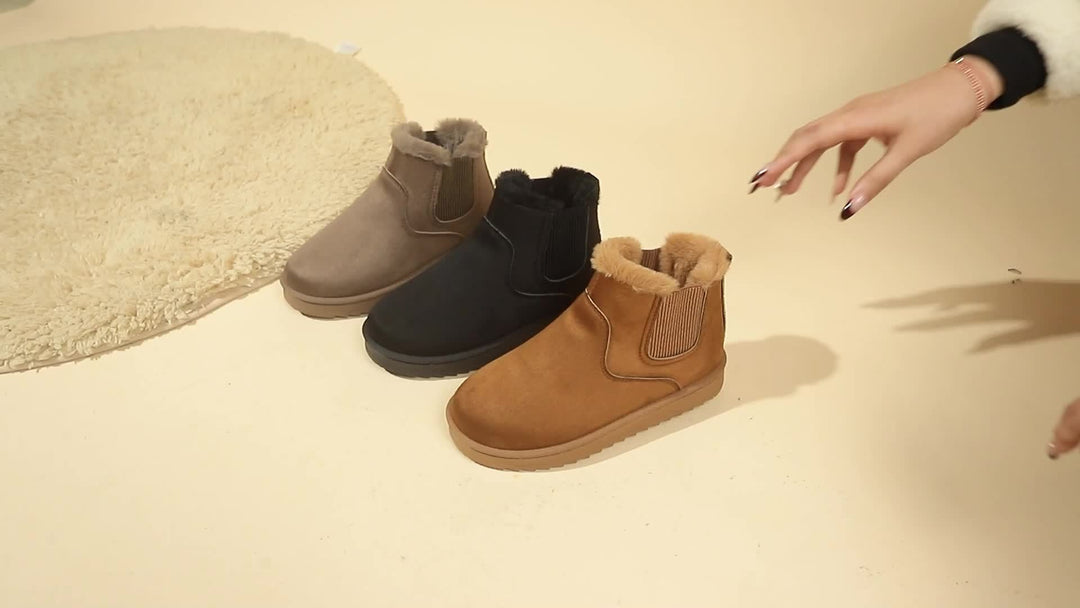 Rosemary ankle boot held by hand showing plush lining detail