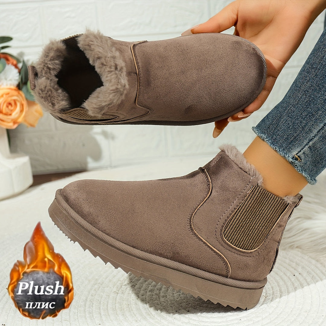 Rosemary ankle boot held by hand showing plush lining detail