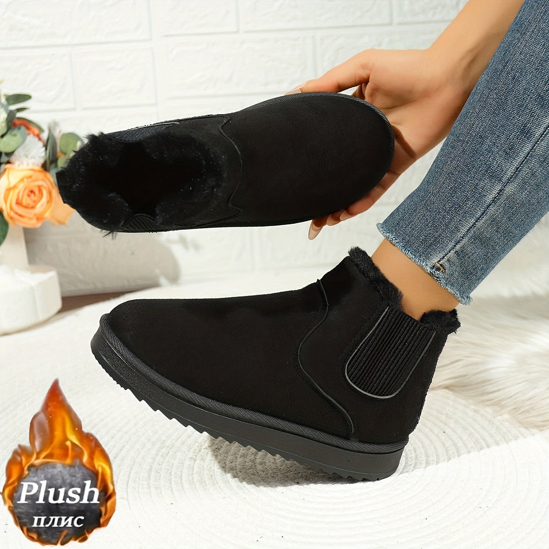 Rosemary ankle boot held by hand showing plush lining detail