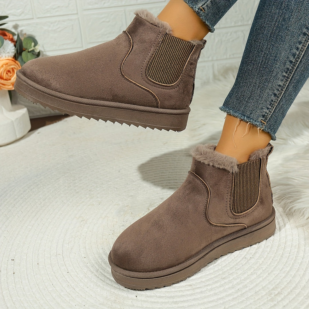 Rosemary ankle boot held by hand showing plush lining detail