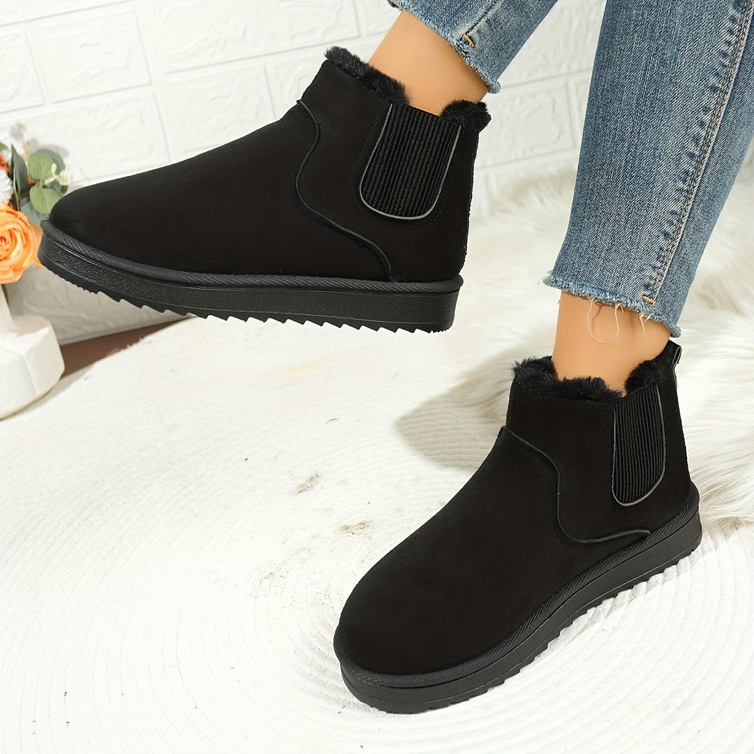 Rosemary ankle boot held by hand showing plush lining detail