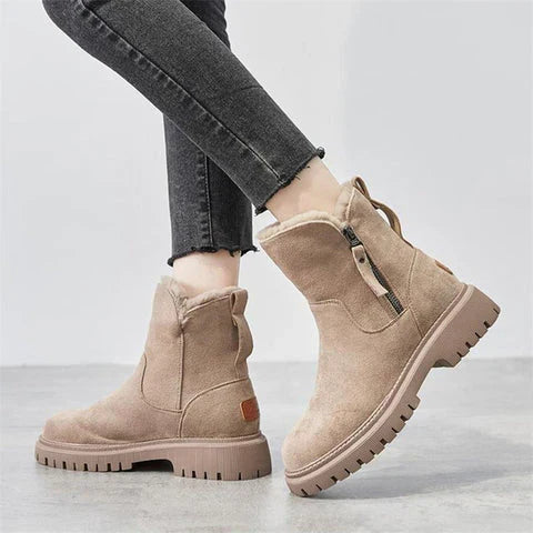 Marigold beige ankle boots worn with jeans, close-up side view