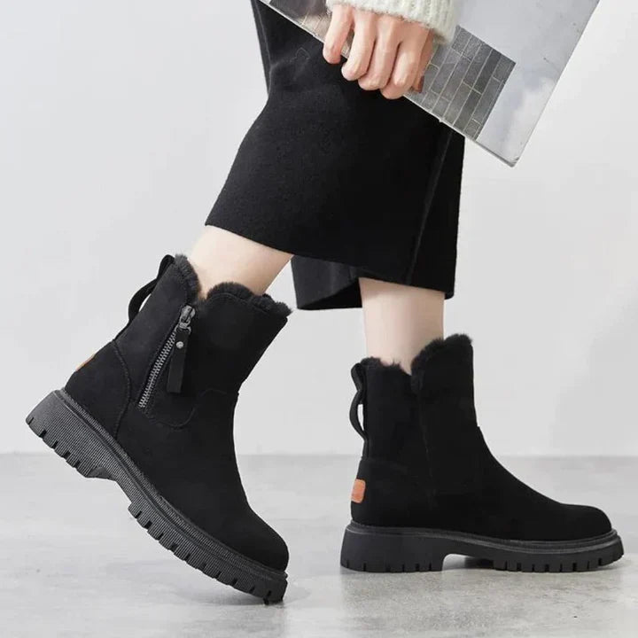 Marigold black ankle boots worn walking, side view