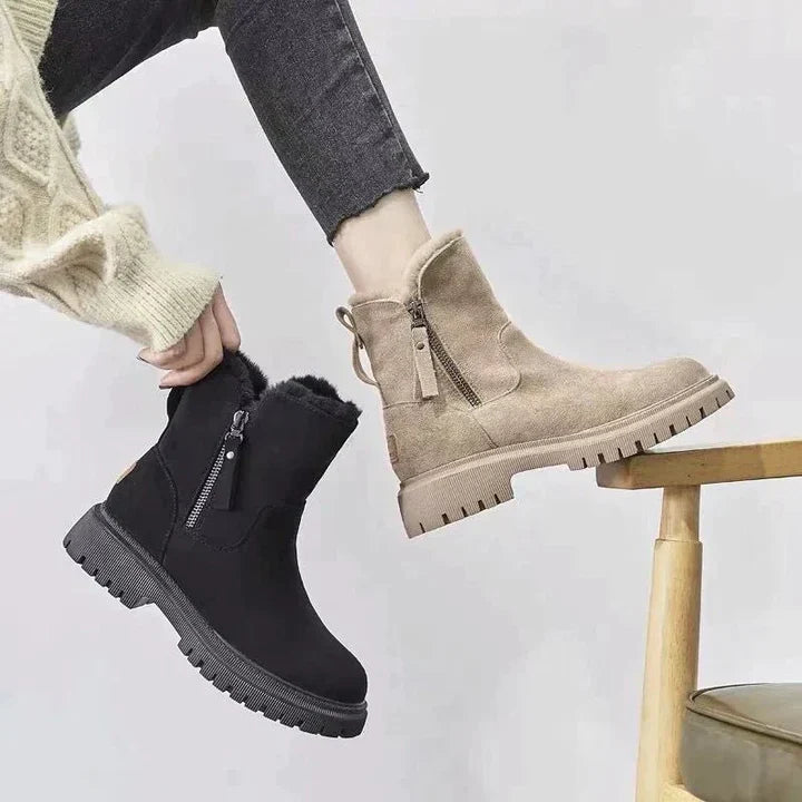 Marigold black ankle boots worn walking, side view