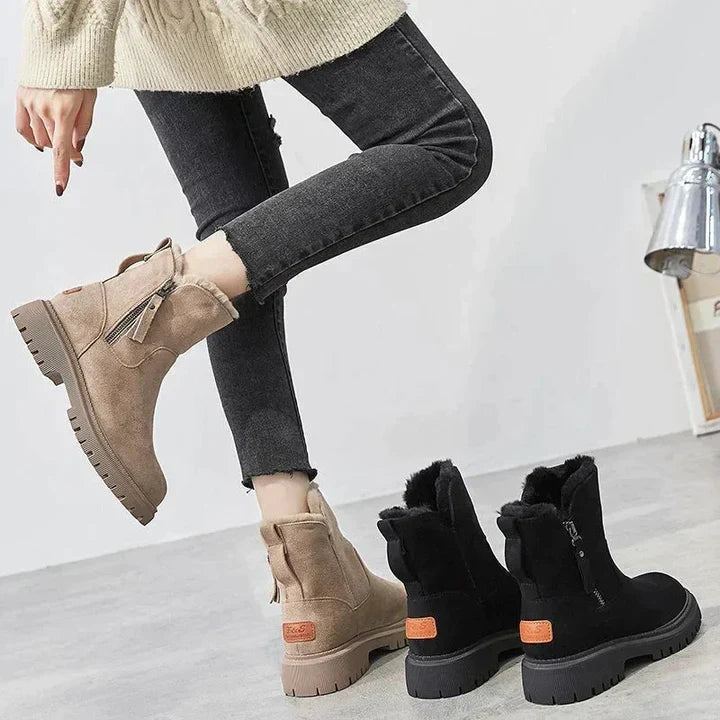 Marigold black ankle boots worn walking, side view