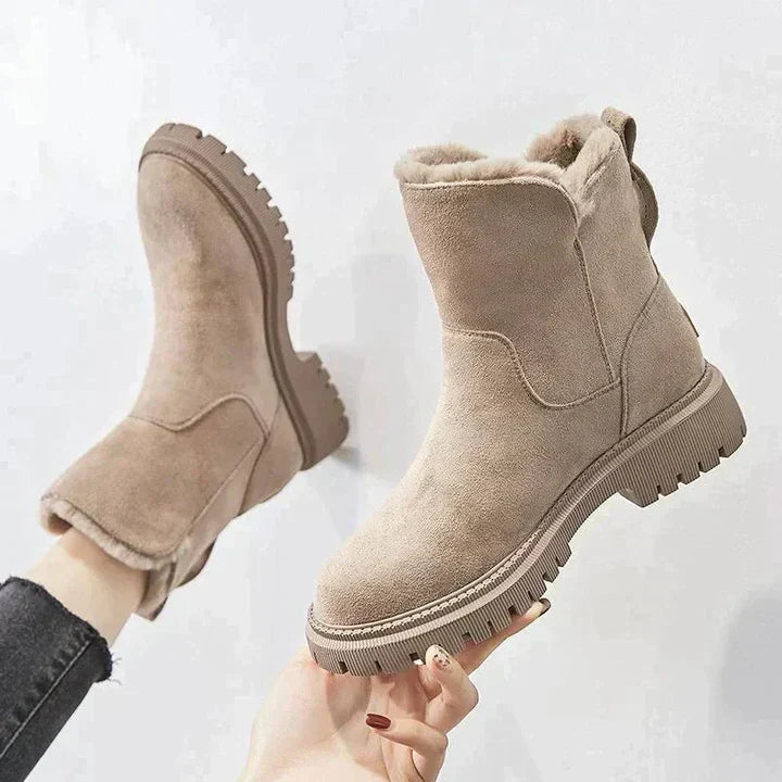 Marigold black ankle boots worn walking, side view