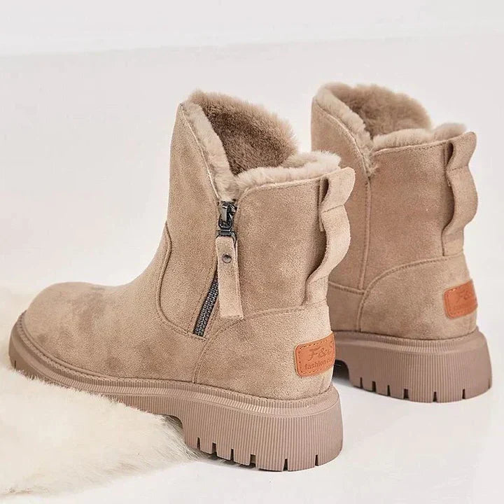 Marigold black ankle boots worn walking, side view