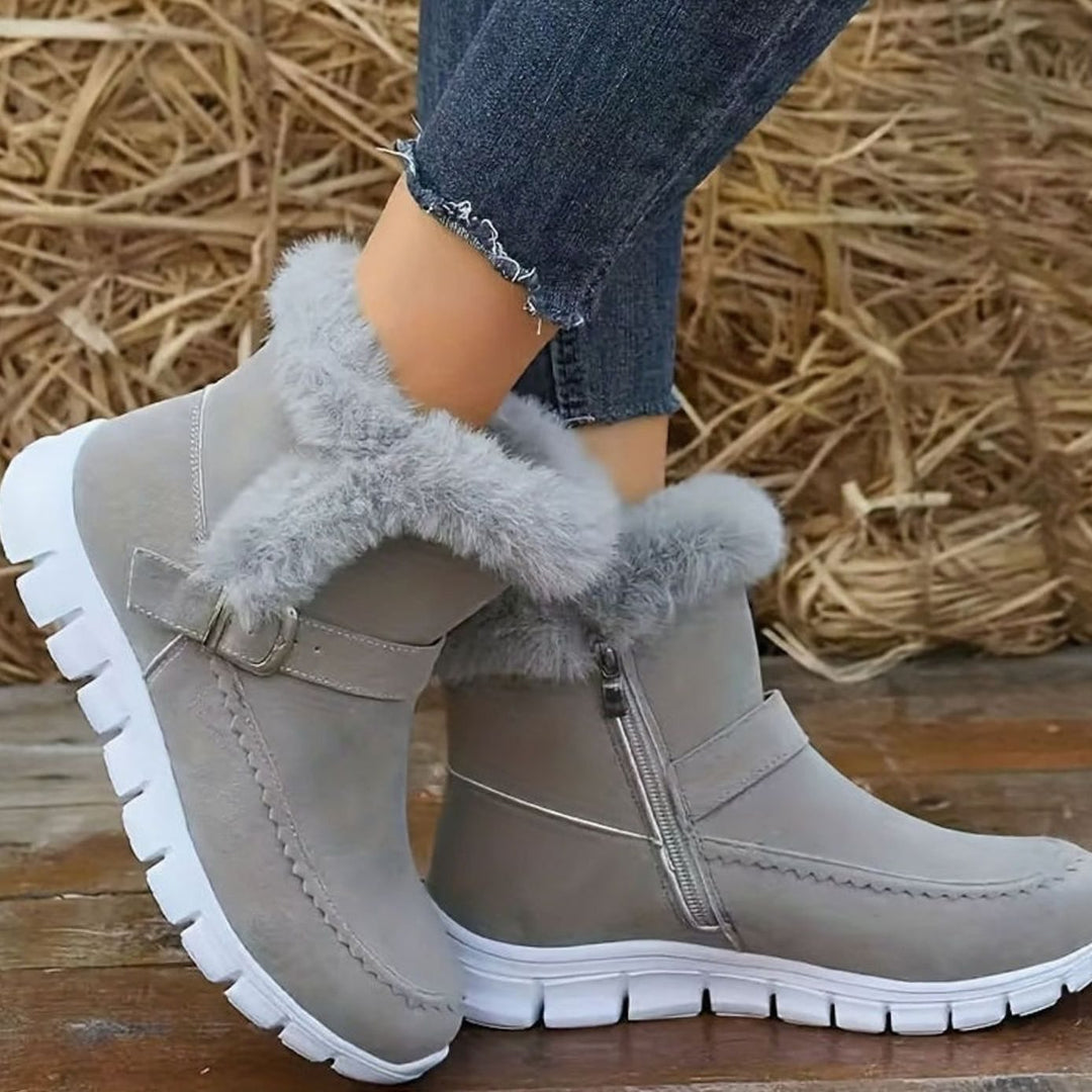 Faustine plush trim ankle snow boots in grey, side view on model