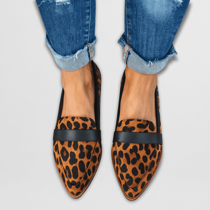Leopard print pointed toe loafers worn with cuffed jeans, front view