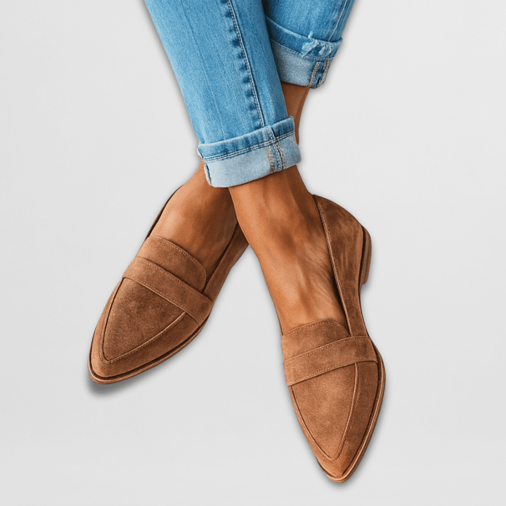 Marcella suede loafers in tan worn with cuffed jeans, crossed feet front view