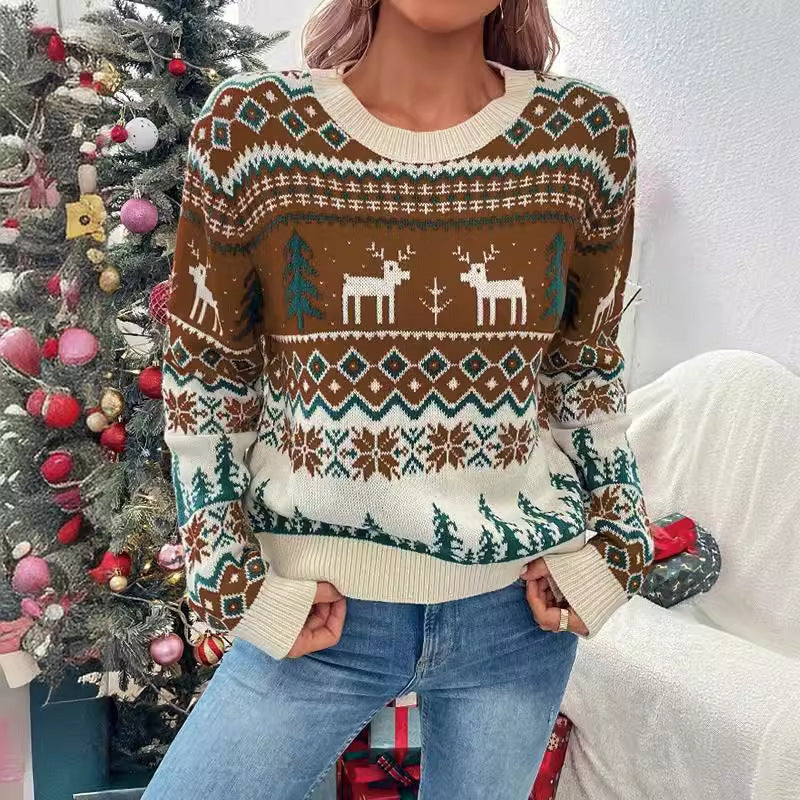 Marigolde reindeer print Christmas sweater, front view with hands in pockets