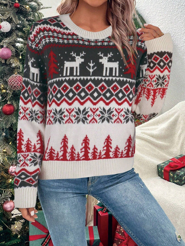 Marigolde reindeer print Christmas sweater, front view with hands in pockets