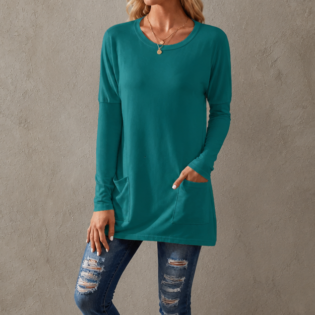 Harlow tunic top, back view paired with leggings and sneakers