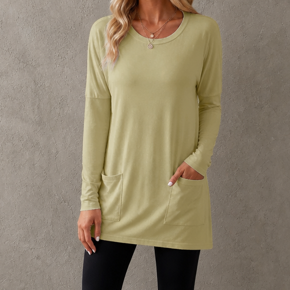 Harlow tunic top, back view paired with leggings and sneakers