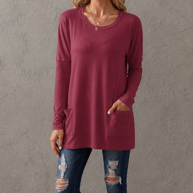 Harlow tunic top, back view paired with leggings and sneakers